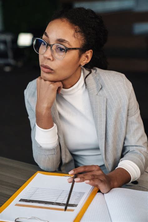 Image Of African American Businesswoman Working With Papers In Office