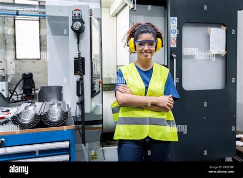 Maintenance Engineer In Reflective Clothing Standing With Arms Crossed