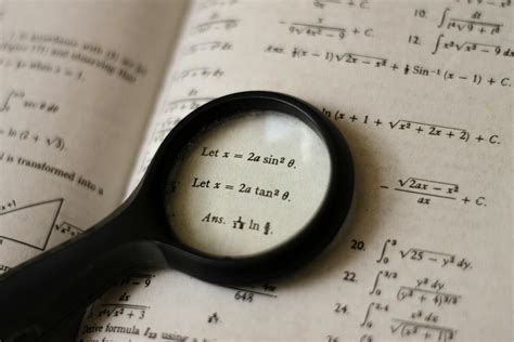 Magnifying Glass on Textbook · Free Stock Photo