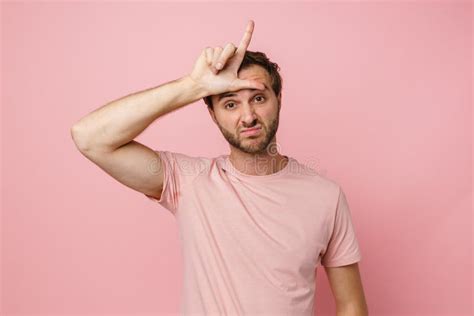 Sad Man Doing Loser Gesture With Hand On His Forehead And Looking At Camera Isolated Stock Image