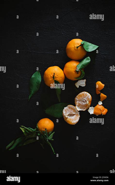 Peeled And Unpeeled Mandarin Oranges Stock Photo Alamy