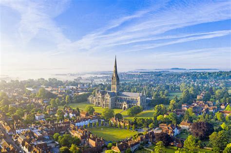 Aerial View Over Salisbury And Salisbury Cathedral On A Misty Summer