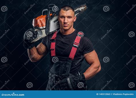 brutal logger posing   chainsaw   shoulder
