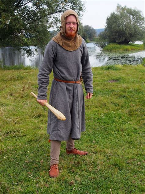 a man dressed in medieval clothing holding a baseball bat and wearing a ...