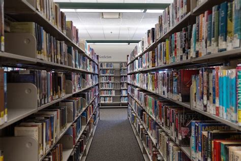 The Fiction Aisle of a Public Library Showing Rows of Books Editorial ...