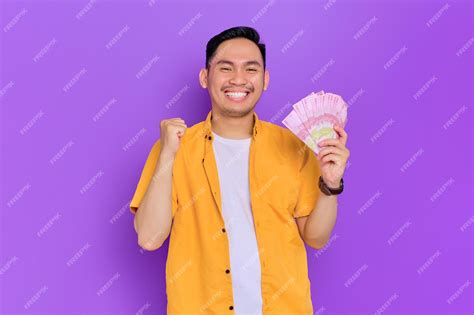 Premium Photo Excited Handsome Young Asian Man Holding Money