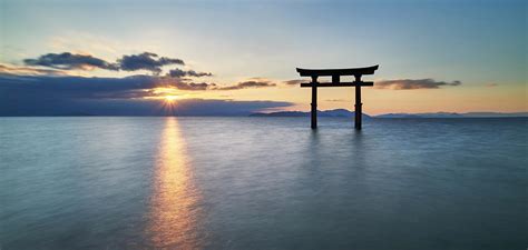 Long Exposure Shot Of Shirahige Shrine Torii Gate At Sunrise Lake Biwa