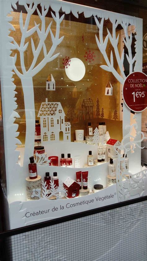 A Window Display With Candles And Christmas Decorations