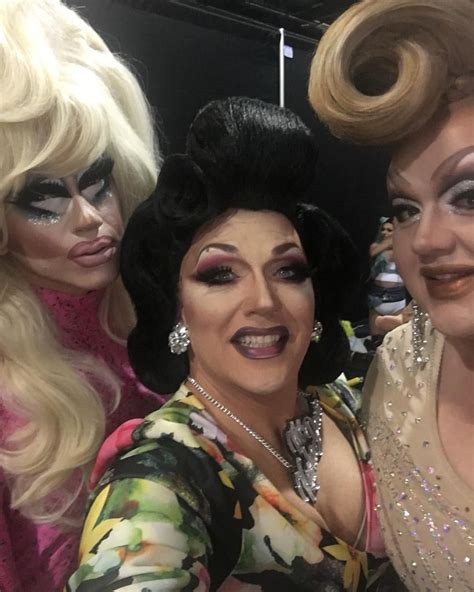 Three Women Dressed Up In Wigs And Makeup Posing For The Camera