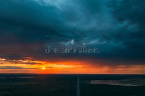 Aerial View Of Sunset Sky Above Highway Road Through Green Forest