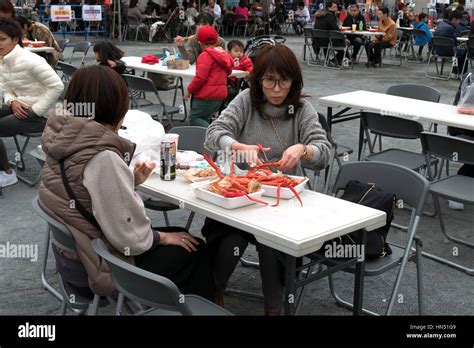 Japanese People Families Tourists Eating Traditional Asian Street Food At City Fair Hiroshima