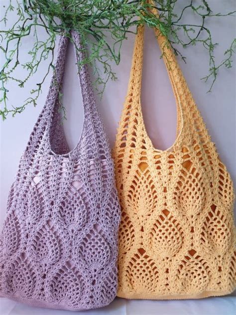 Two Crocheted Purses Sitting Next To Each Other