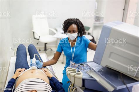 Female Doctor Doing Ultrasound Examination Of A Pregnant Woman Stock