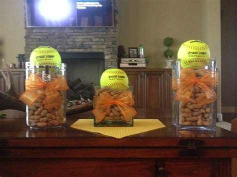 Three Clear Vases With Balls And Bows Are On A Table In Front Of A