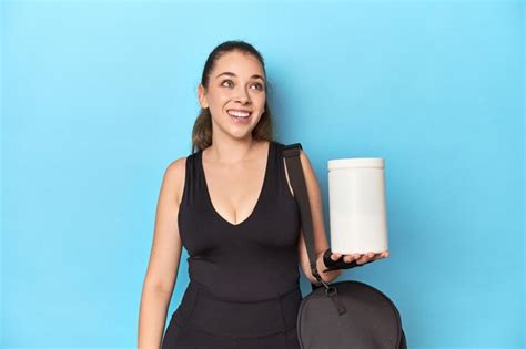 Premium Photo Young Woman Holding Protein Bottle In Sporty Setting