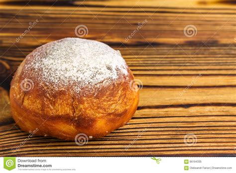 Homemade Fresh Donut Sprinkled With Powdered Sugar On Wooden Table With