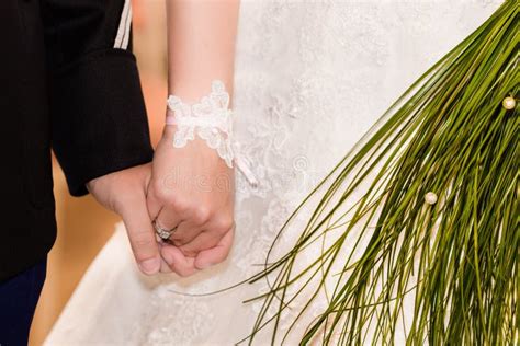 Bride And Groom Holding Hands During Wedding Ceremony Stock Photo