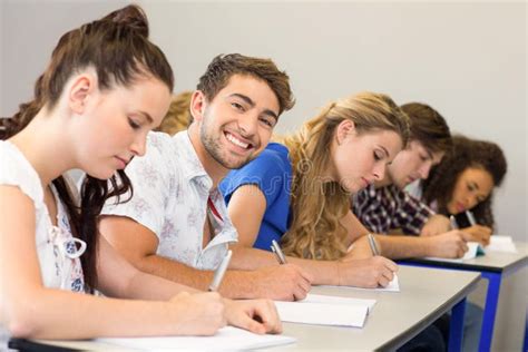 Estudantes Que Escrevem Notas Na Sala De Aula Imagem De Stock Imagem