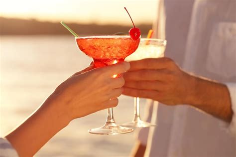 Premium Photo Male And Female Hands Holding Glasses With Margarita