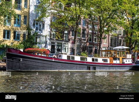 Amsterdam, The Netherlands. Houseboat along an Amsterdam Canal Stock ...