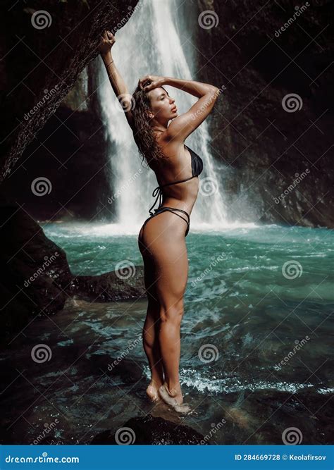 Slim Woman In Bikini Near Waterfall Traveler Girl Posing On Waterfall