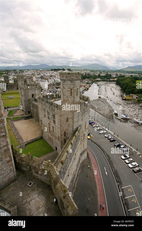 Aerial View Of Caernarfon Castle With River Arfon And Snowdonia