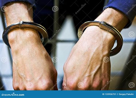 Male Hands In Metal Handcuffs Closeup A Prisoner In Jail Stock Image