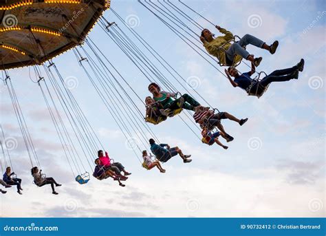 People Have Fun At The Carousel Flying Swing Ride Attraction At