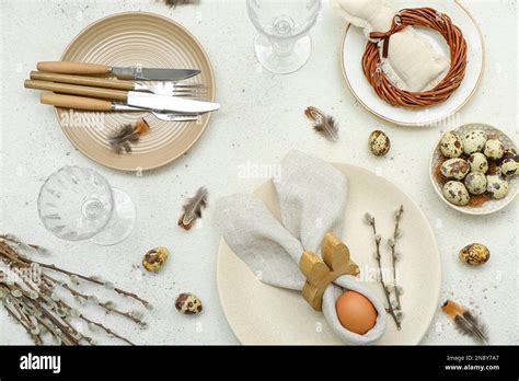 Table Setting With Easter Eggs Pussy Willow Branches And Feathers On