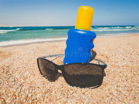 Sunscreen In Sand Against The Sea Stock Photo Image Of Spray