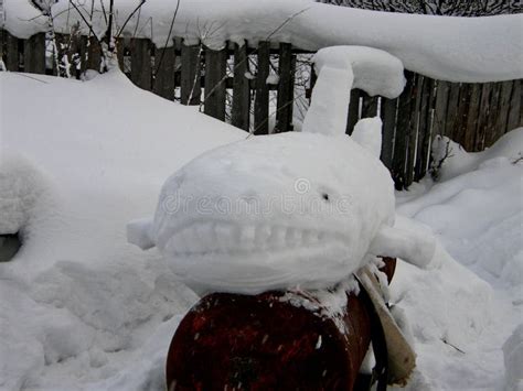 Snow Sculpture of a White Shark on an Old Rusty Tank. Stock Image ...