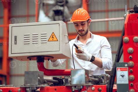 Factory worker checking electrical machine process at industrial