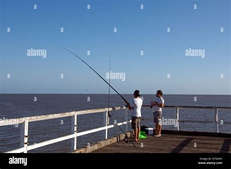 Two Men Fishing From Urangan Pier Hervey Bay Queensland Australia Stock