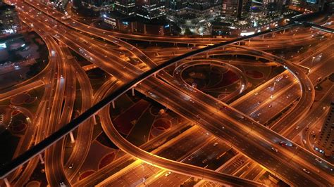 Aerial view of highway and overpass in city at night timelapse 33198049 ...