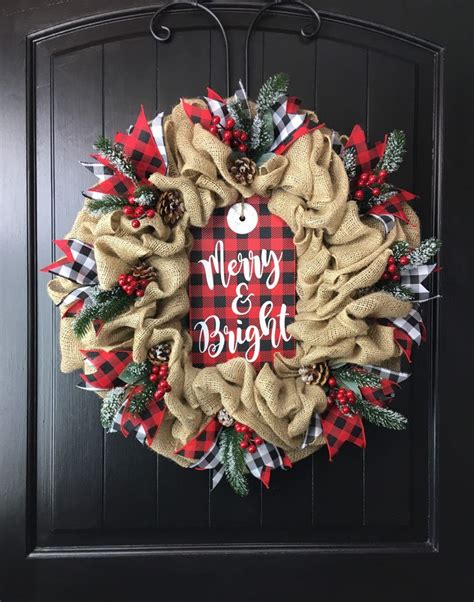 A Merry And Bright Christmas Wreath Hanging On The Front Door With Pine