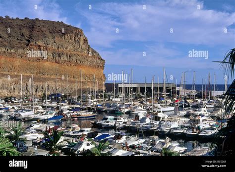 Puerto De Mogan Harbour With A Mass Of Moored Boats Puerto De Mogan