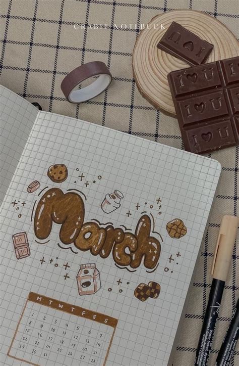 An Open Notebook With The Word March On It Next To Some Chocolate And