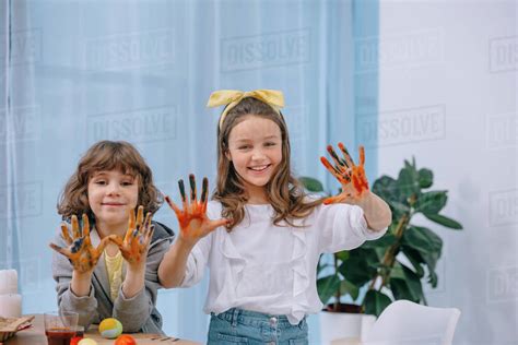 Happy Kids Showing Their Colored Hands After Painting Easter Eggs