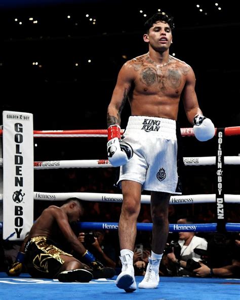 A Man Standing In The Middle Of A Boxing Ring With His Hands On His Hips