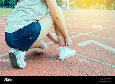 Woman Runner Tying Shoelace On Running Racetrack Stock Photo Alamy