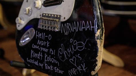 A battered guitar which Nirvana's Kurt Cobain gifted to his friend Mark ...