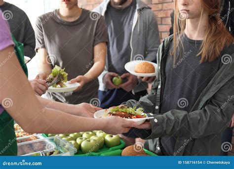 Volunteers Giving Food To Poor People Indoors Stock Photo Image Of