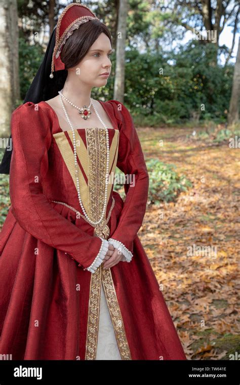 Tudor Woman In Red Dress Walking In Garden Stock Photo Alamy