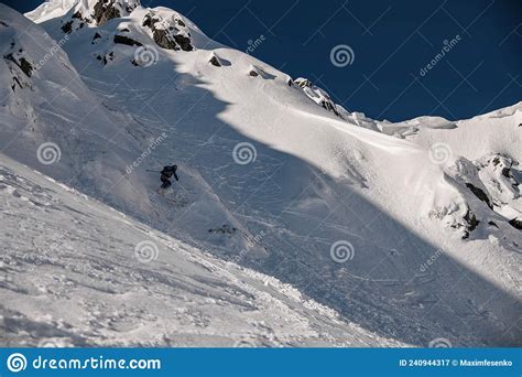 Great View Of The Rocky Snow Covered Mountain Slope And The Skier