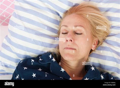 Mature Woman Sleeping In Bed Stock Photo Alamy