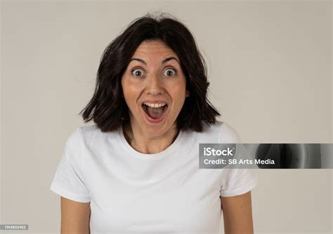 Portrait Of Beautiful Shocked Woman Hearing Good News Or Having Great