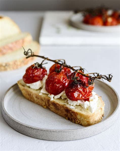 Tomato Confit And Goat Cheese Bruschetta On Grey Concrete Table Stock Image Image Of Food