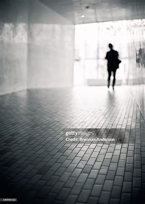 Lone Man Walking Down Hallway High Res Stock Photo Getty Images