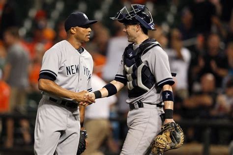 Two Baseball Players Shake Hands On The Field