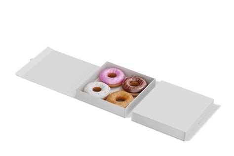 Una Caja De Donuts Con Glaseado Rosa Y Morado Foto Premium